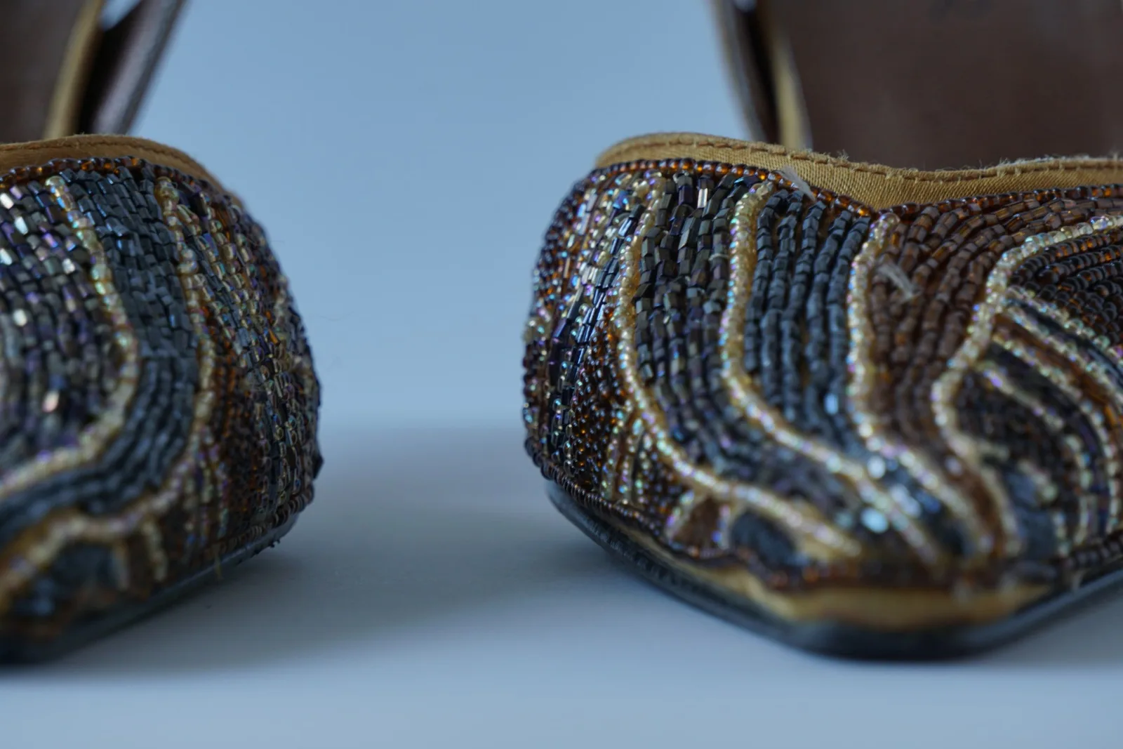Close-up of the bijou toe boxes showing the flowing metallic bead pattern.