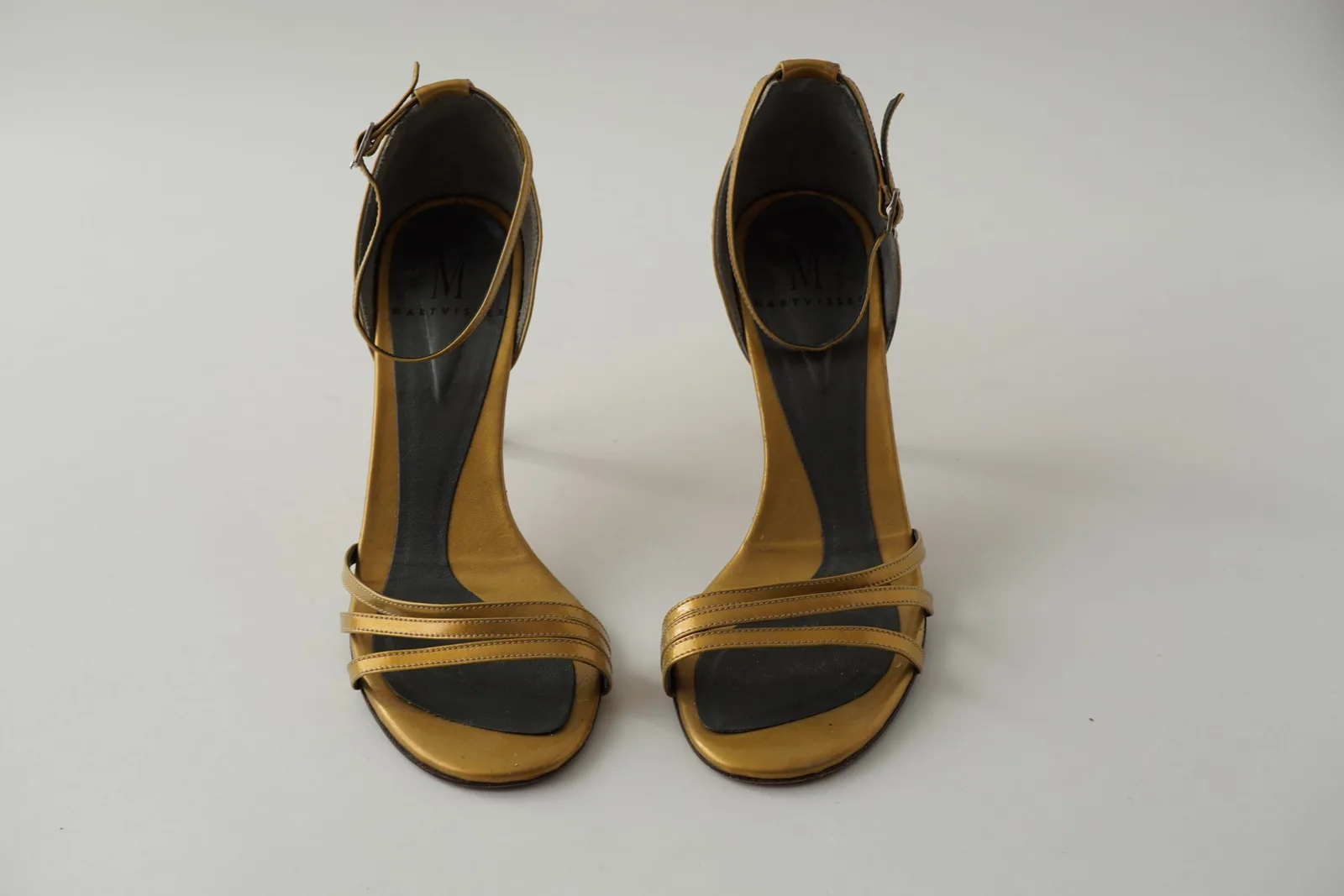 Front view of the pair of miel sandals showing the open toes and gold straps.