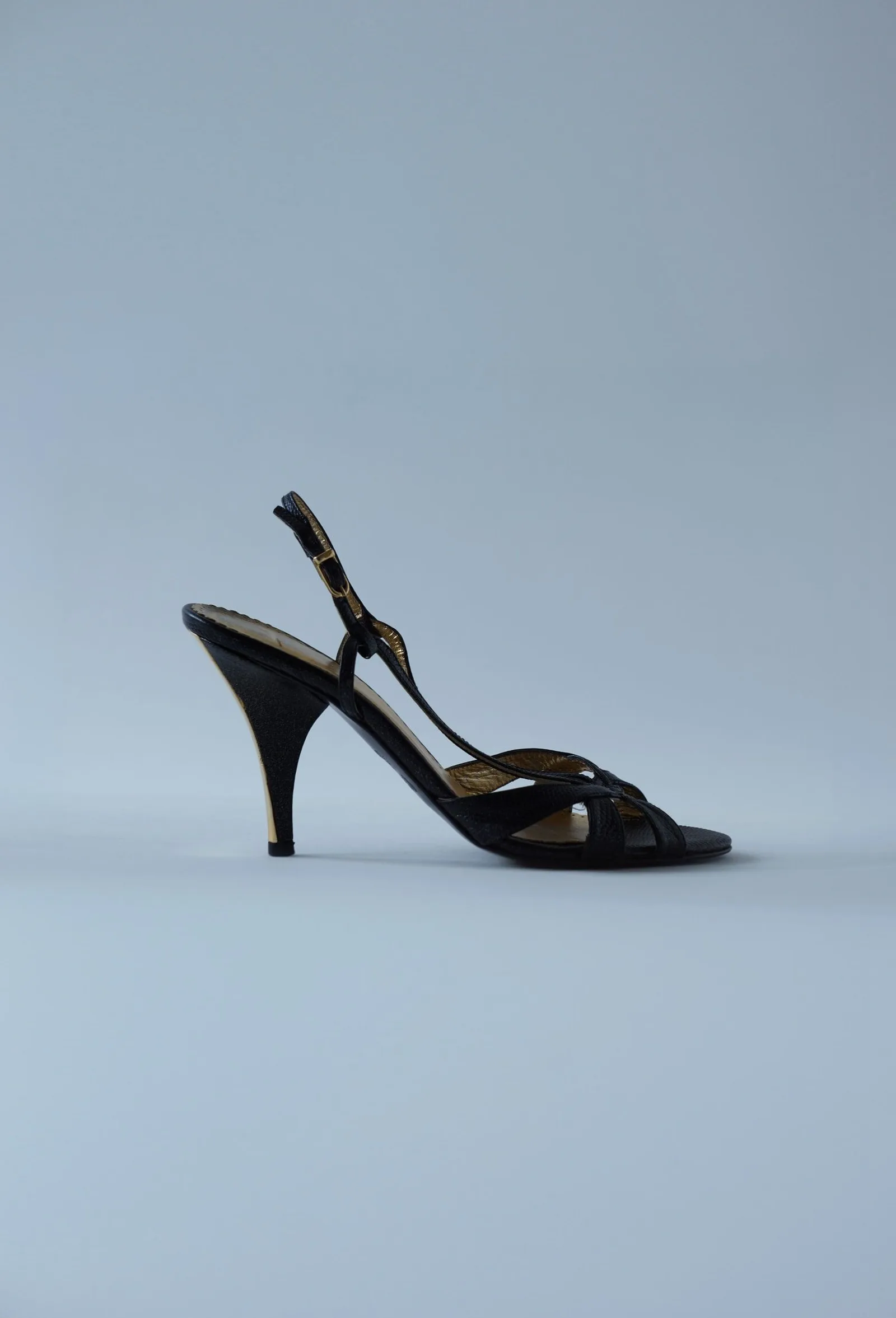 Chocolate-brown slingback stiletto with a curved front strap, shown in side profile.